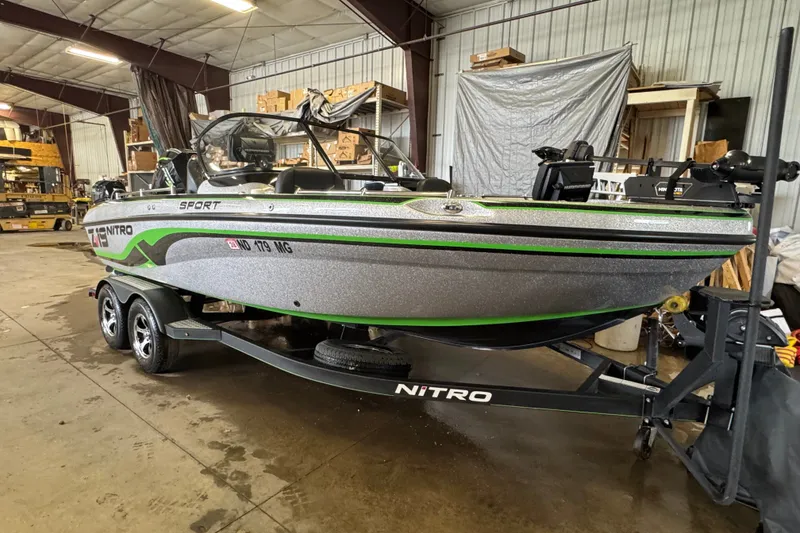 Slide: The Image of 2021 Nitro ZV19 Sport boat in a warehouse, featuring sleek design and vibrant green accents. - 2