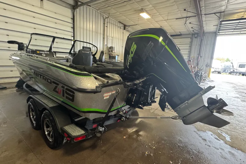 Slide: The Image of 2021 Nitro ZV19 Sport boat in garage, featuring powerful outboard motor. - 4