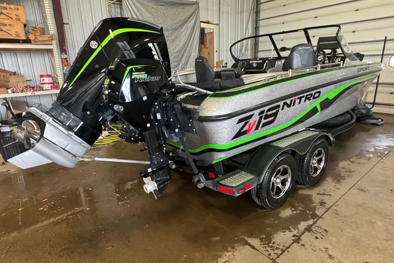 Slide: The Image of 2021 Nitro ZV19 Sport boat with Mercury engine in a garage setting. - 3