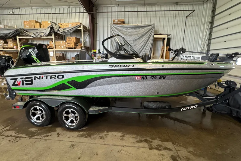 The Image of 2021 Nitro ZV19 Sport boat in a warehouse, featuring sleek design and vibrant green accents. - 0