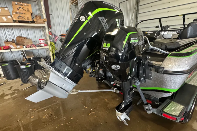 Slide: The Image of 2021 Nitro ZV19 Sport boat with dual Mercury outboard motors in a garage setting. - 5