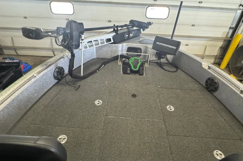 Slide: The Image of 2021 Nitro ZV19 Sport boat interior with Humminbird electronics and trolling motor in a garage. - 12