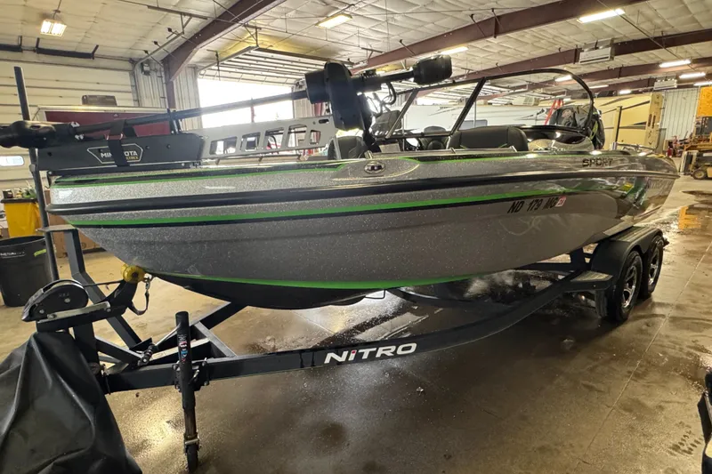 Slide: The Image of 2021 Nitro ZV19 Sport boat on trailer in indoor garage setting. - 1