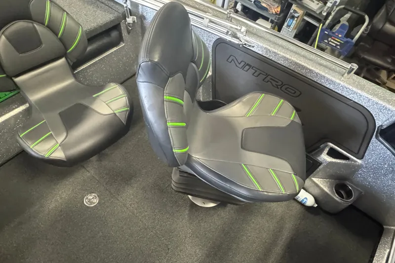 Slide: The Image of 2021 Nitro ZV19 Sport boat interior with black and green seats. - 8