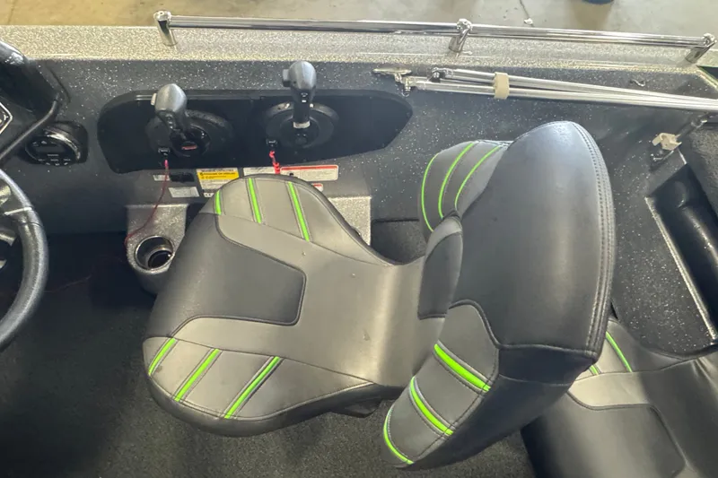 Slide: The Image of 2021 Nitro ZV19 Sport boat interior with black and green seating and controls. - 7