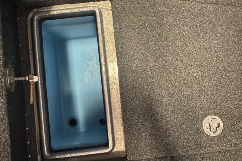 Slide: The Image of Livewell compartment in a 2021 Nitro ZV19 Sport boat, featuring a blue interior. - 20
