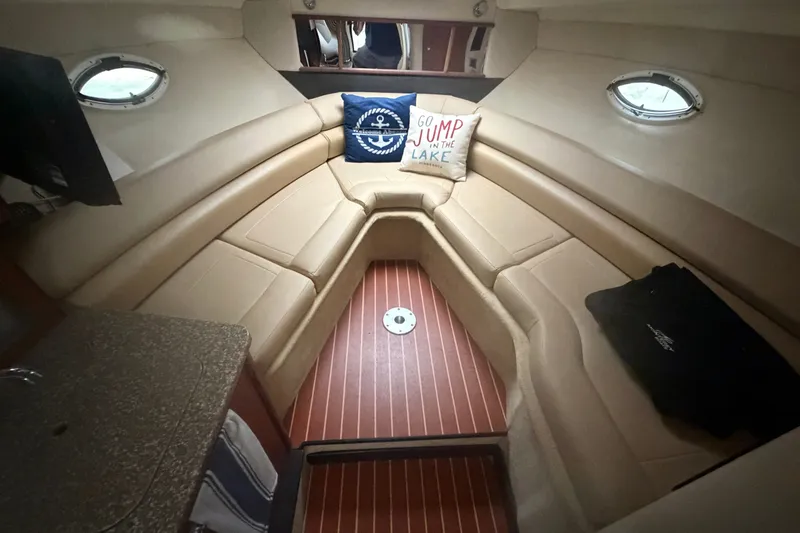 Slide: The Image of Interior of a 2011 Monterey 280 SCR boat with beige seating and decorative pillows. - 19