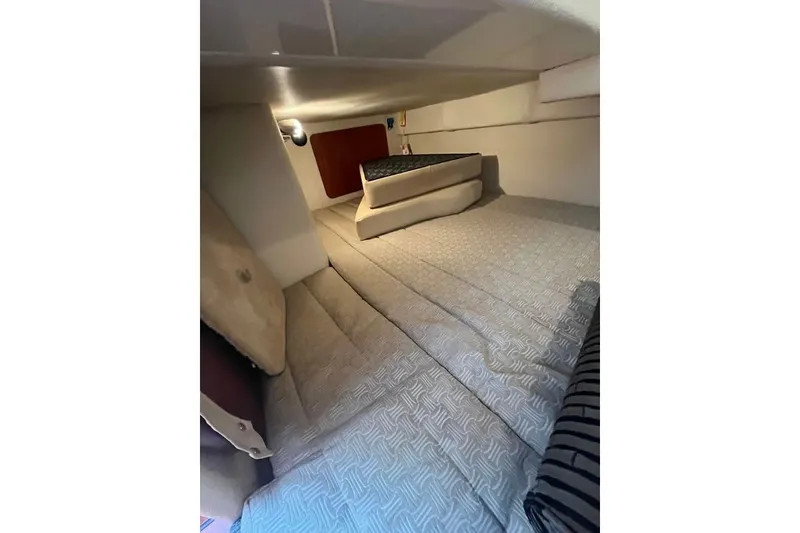 Slide: The Image of Interior cabin of 2011 Monterey 280 SCR boat with cozy bedding and cushions. - 28