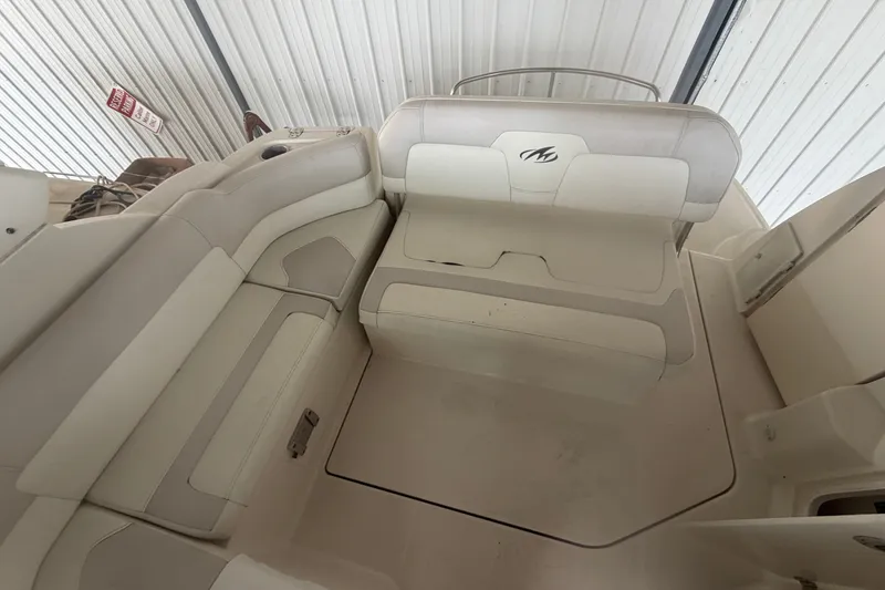 Slide: The Image of 2011 Monterey 280 SCR boat interior with white seating and storage compartments. - 15