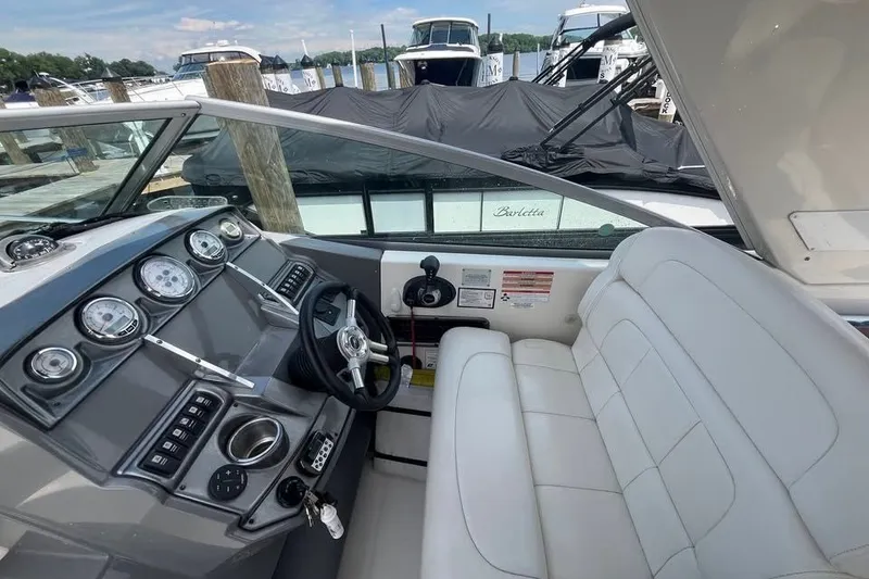 Slide: The Image of Interior of a 2011 Monterey 280 SCR boat with steering wheel and gauges. - 24