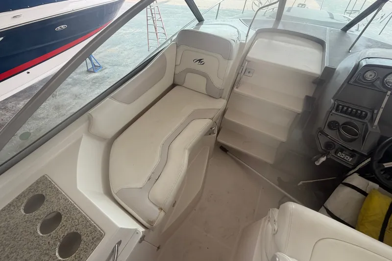 Slide: The Image of Interior of a 2011 Monterey 280 SCR boat with white seating and control panel. - 14