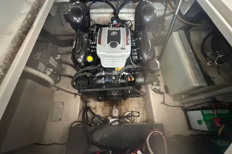 Slide: The Image of Engine compartment of a 2011 Monterey 280 SCR boat, showcasing the engine and surrounding components. - 29
