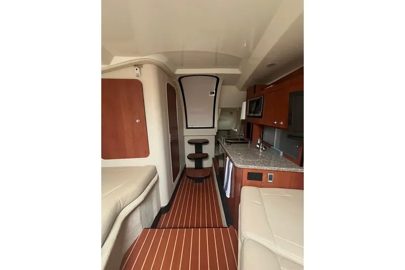 Slide: The Image of Interior of a 2011 Monterey 280 SCR boat with modern kitchen and seating area. - 27