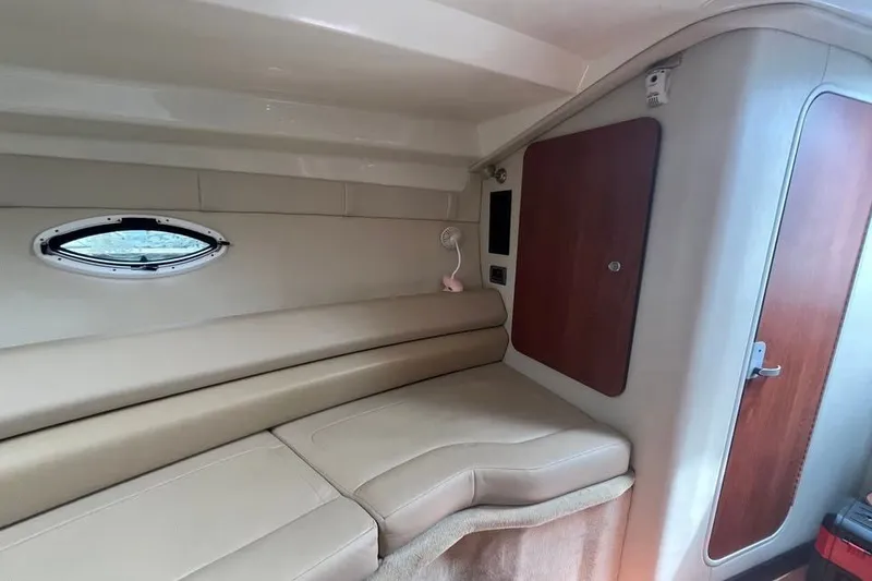 Slide: The Image of Interior cabin of 2011 Monterey 280 SCR boat with beige seating and wooden accents. - 25