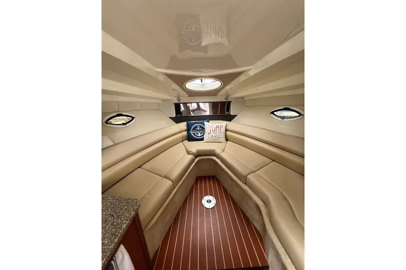 Slide: The Image of Luxurious interior of 2011 Monterey 280 SCR boat with beige seating and wood flooring. - 22