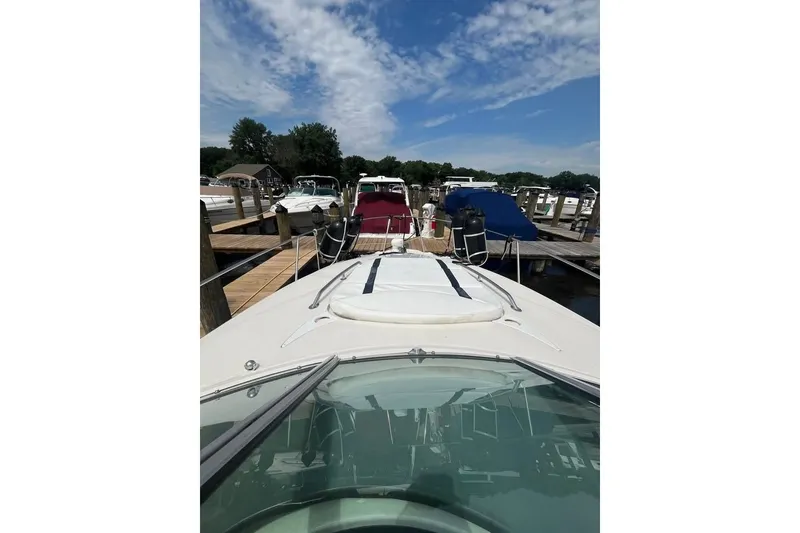 Slide: The Image of 2011 Monterey 280 SCR boat docked at marina under blue sky. - 18