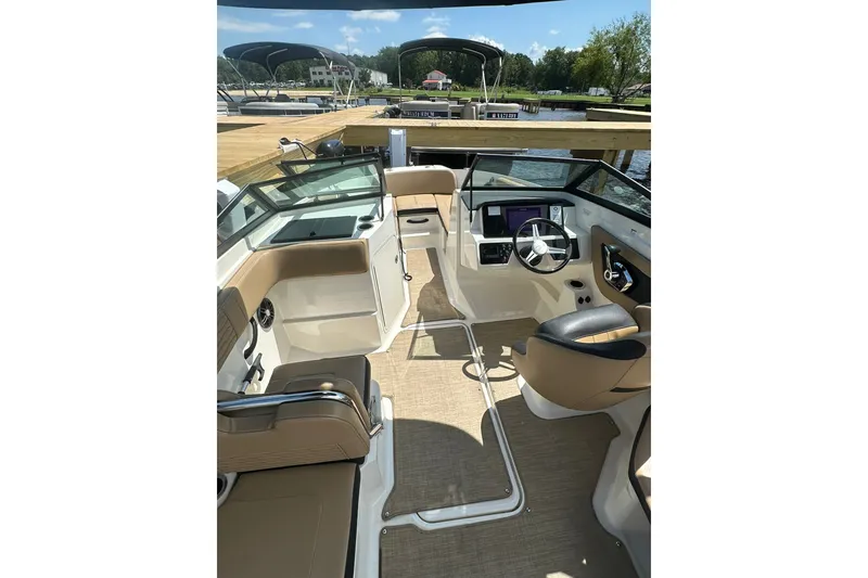 Slide: The Image of 2023 Sea Ray SPX 210 Outboard boat interior with modern helm and seating. - 7