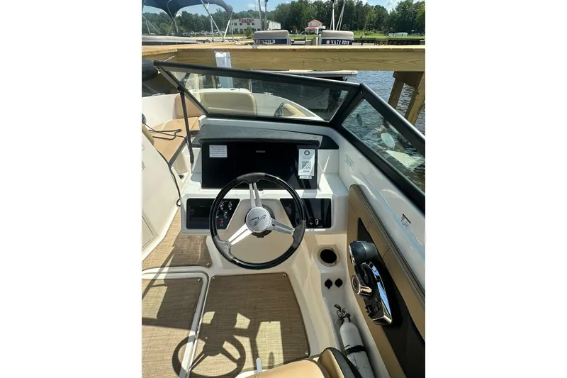 Slide: The Image of 2023 Sea Ray SPX 210 Outboard boat cockpit with steering wheel and controls. - 8