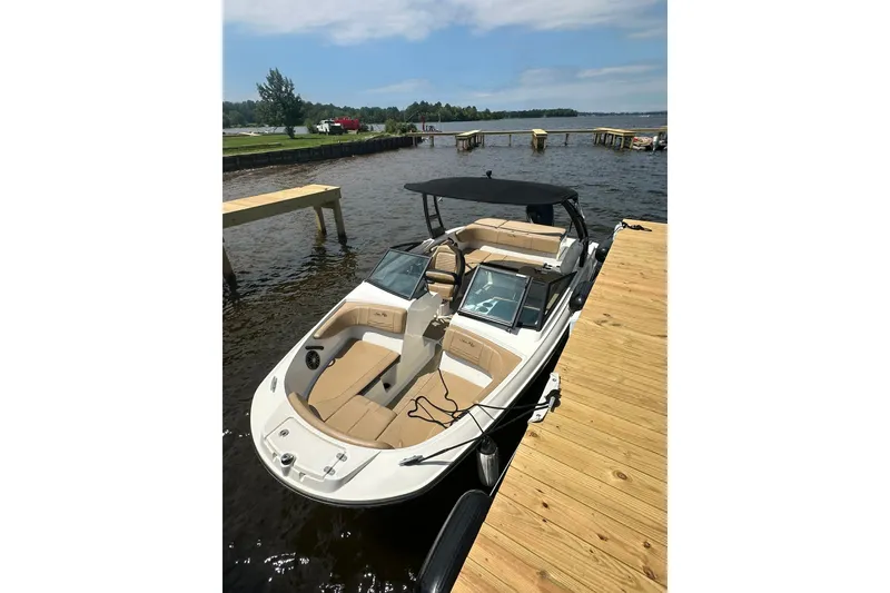 Slide: The Image of 2023 Sea Ray SPX 210 Outboard boat docked on a sunny day. - 3