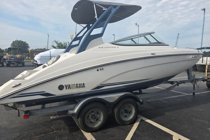 Slide: The Image of 2018 Yamaha Boats 212 Limited S on trailer, parked outdoors. - 2