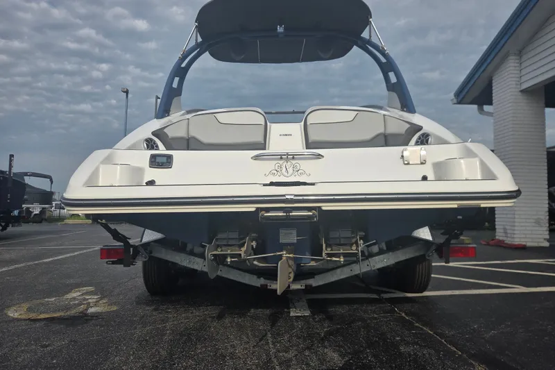 Slide: The Image of 2018 Yamaha Boats 212 Limited S on trailer, rear view, parked outdoors. - 3