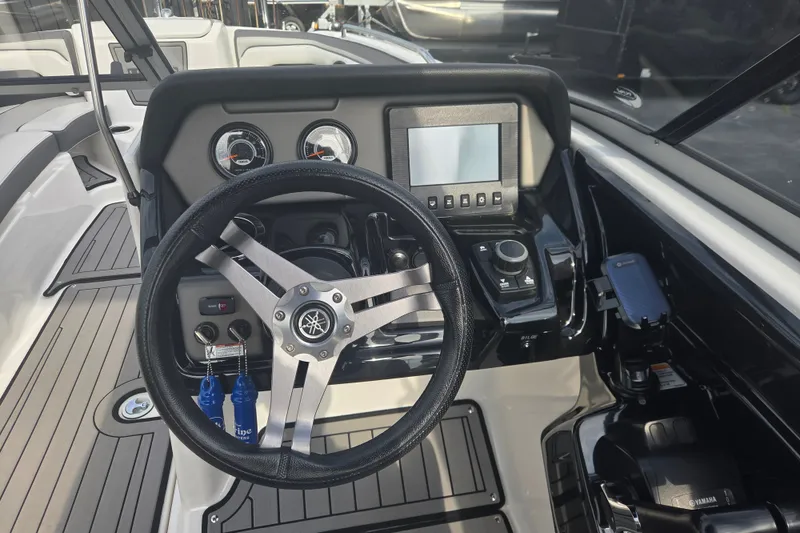 Slide: The Image of 2018 Yamaha Boats 212 Limited S dashboard with steering wheel and control panel. - 5