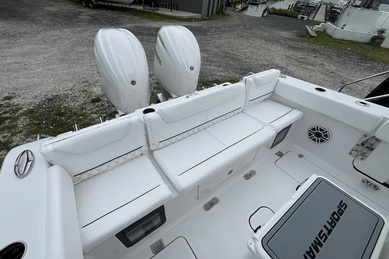 Slide: The Image of 2027 Sportsman Heritage 261 Center Console boat with dual engines and white seating. - 3