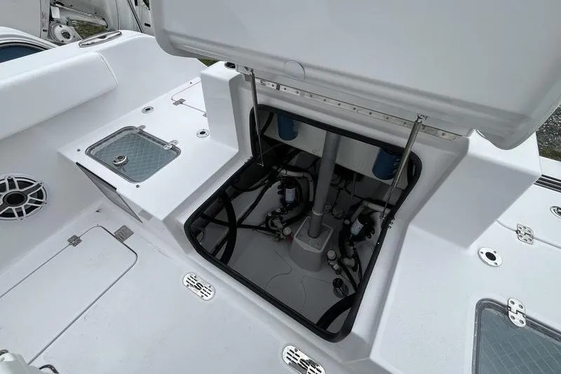 Slide: The Image of 2027 Sportsman Heritage 261 Center Console boat interior with open hatch and visible wiring. - 5