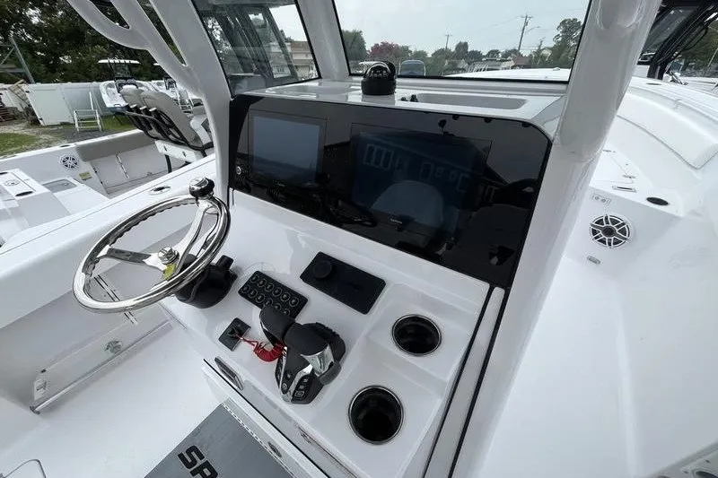 Slide: The Image of 2027 Sportsman Heritage 261 Center Console boat dashboard with steering wheel and controls. - 6