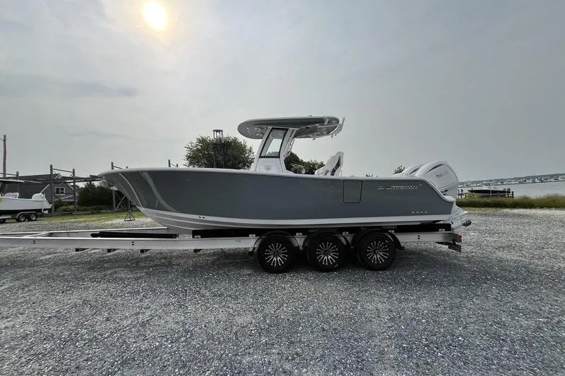 The Image of 2027 Sportsman Heritage 261 Center Console boat on trailer, parked outdoors. - 0