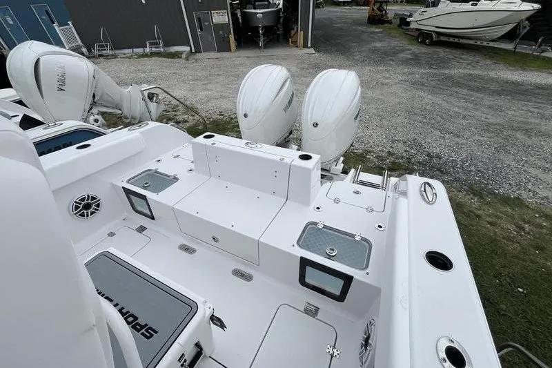 Slide: The Image of 2027 Sportsman Heritage 261 Center Console boat with dual Yamaha engines, docked outdoors. - 4