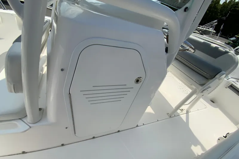 Slide: The Image of 2016 Everglades 230 Center Console boat interior with storage compartment and seating. - 26