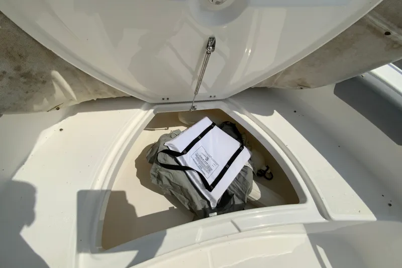 Slide: The Image of Storage compartment of 2016 Everglades 230 Center Console boat with gear inside. - 21