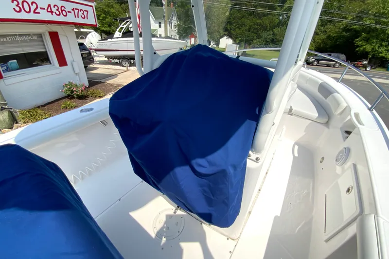 Slide: The Image of 2016 Everglades 230 Center Console boat interior with blue seat covers. - 29