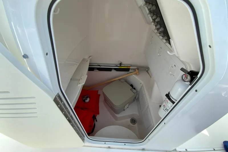 Slide: The Image of Interior of 2016 Everglades 230 Center Console boat with storage and safety equipment. - 27