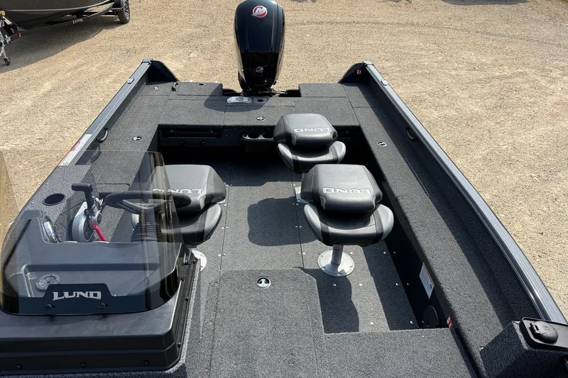 Slide: The Image of 2027 Lund 1800 Adventure SS boat interior with seating and steering wheel. - 9