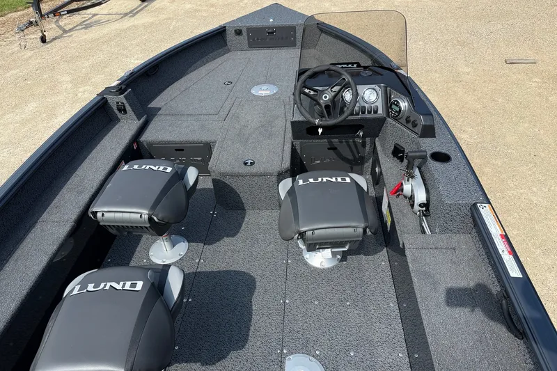 Slide: The Image of 2027 Lund 1800 Adventure SS boat interior with steering console and seating. - 4