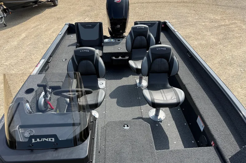 Slide: The Image of 2027 Lund 1800 Adventure SS boat interior with four seats and steering console. - 10