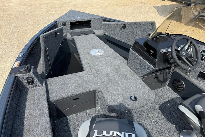 Slide: The Image of 2027 Lund 1800 Adventure SS boat interior with steering console and seating. - 5
