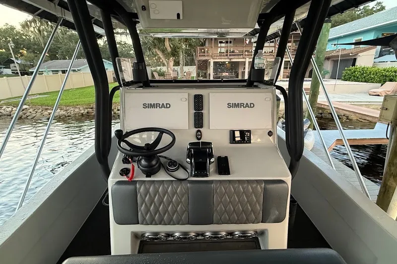 Slide: The Image of 2025 Shallow Sport 32 X3 boat cockpit with Simrad navigation system. - 10
