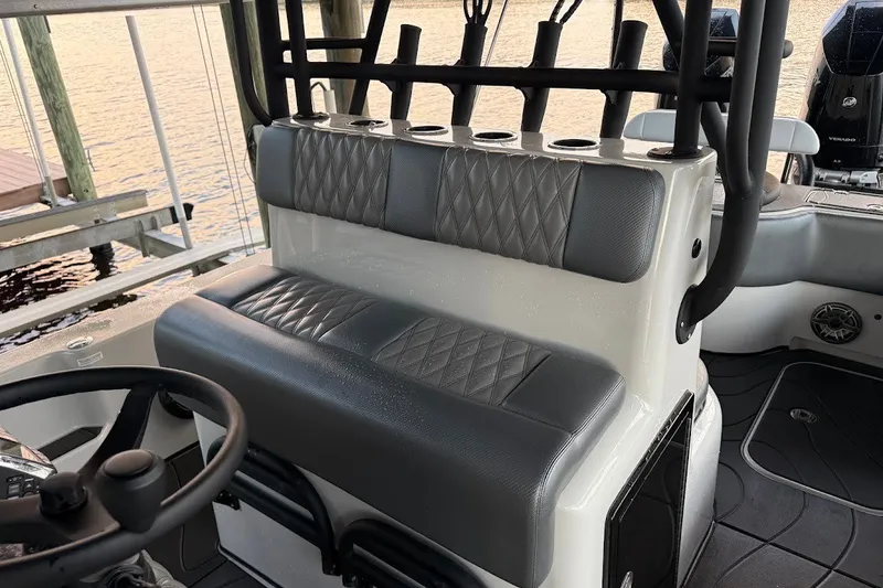 Slide: The Image of 2025 Shallow Sport 32 X3 boat interior with cushioned seating and steering wheel. - 20