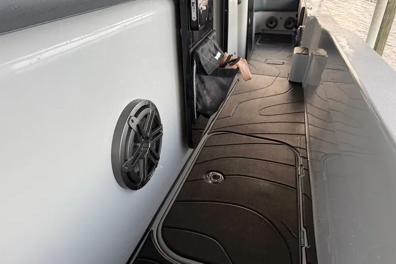 Slide: The Image of 2025 Shallow Sport 32 X3 boat interior with speaker and storage features. - 14