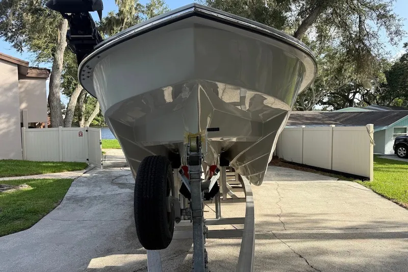 Slide: The Image of 2025 Shallow Sport 32 X3 boat on trailer in residential driveway. - 2