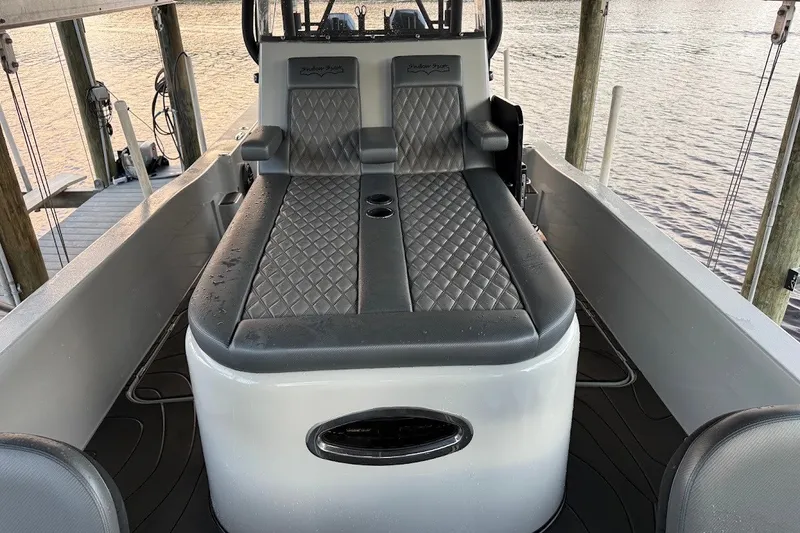 Slide: The Image of 2025 Shallow Sport 32 X3 boat interior with diamond-stitched seating and cup holders. - 15