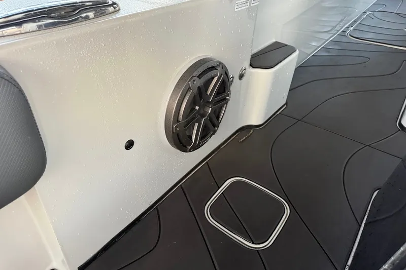 Slide: The Image of Interior of 2025 Shallow Sport 32 X3 boat with speaker and black flooring. - 18