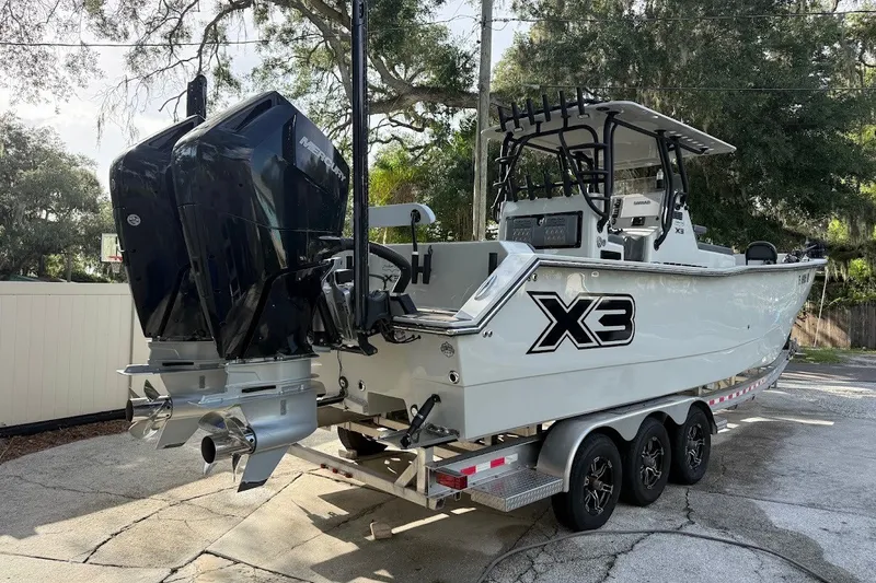 Slide: The Image of 2025 Shallow Sport 32 X3 boat on trailer with dual Mercury engines. - 3