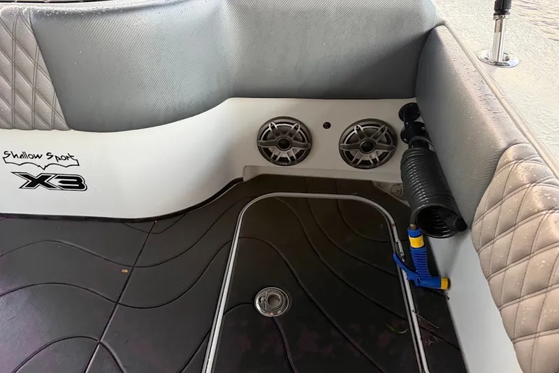 Slide: The Image of 2025 Shallow Sport 32 X3 boat interior with speakers and quilted upholstery. - 16