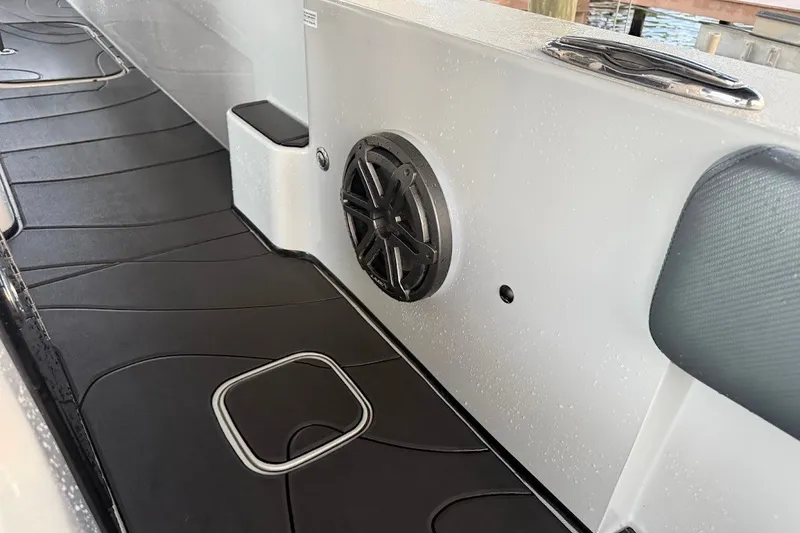 Slide: The Image of Interior of 2025 Shallow Sport 32 X3 boat with speaker and sleek flooring. - 19