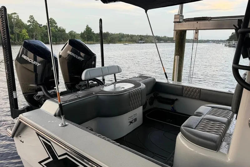 Slide: The Image of 2025 Shallow Sport 32 X3 boat with dual Mercury engines on a calm river. - 4