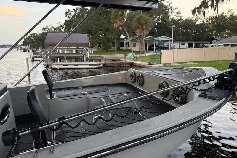 Slide: The Image of 2025 Shallow Sport 32 X3 boat docked by a lakeside with modern interior design. - 6